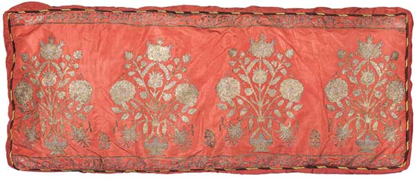 Silk Cushion cover, Deccan, 18th century, 46 x 88 cms. Cushion cover embroidered with gold and silver. Bright pink silk taffeta finely embroidered with carnations in vases in chain stitch. The repeated inscription which is in Turkish reads as follows 'cürmimizi afv iden', 'The One who forgives our sins'